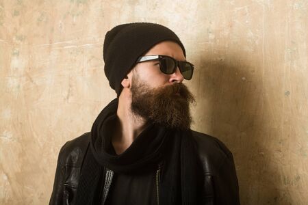 Man with long beard and mustache. Guy with serious face. Biker fashion and beauty. Fashion model on...