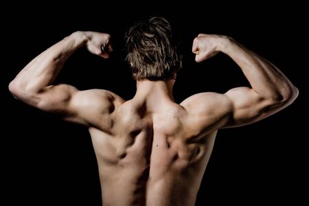 bodybuilder with sexy muscular body and back posing and showing biceps and triceps isolated on white backgroundの写真素材