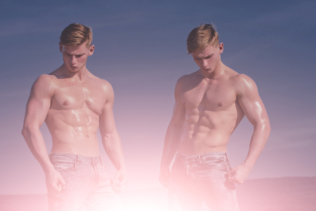 Gladiator or atlant. Athletic bodybuilders pose as hercules. Sport and workout. Men with muscular wet body. Guys with glitter on bare chest.の写真素材