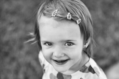 baby girl in dress smiles on sunny summer day on natural background, black and whiteの写真素材
