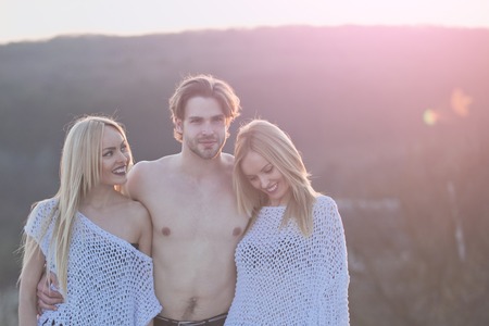 Beauty and fashion. Blonde and guy with athletic chest. Girl and women with boyfriend outdoor. Man with muscular body with twins. Love and romance.の写真素材