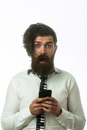 businessman with surprised face and long beard in shirt hold mobile phone isolated on white backgroundの写真素材