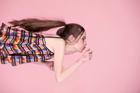 Fun and joy. Beauty and fashion. Bubble blower in hand of fashion model. Girl with glamour makeup...