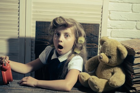 Education and childhood. Kid with book. Little baby secretary. Small girl with curler in hair. Child...