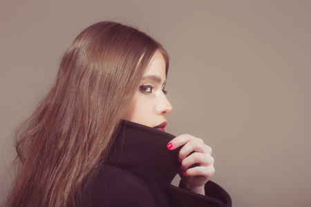 Cosmetics and skincare. Woman has stylish long hair in earrings. Hairdresser and barber. Girl with fashionable makeup. Beauty salon and fashion, copy spaceの写真素材