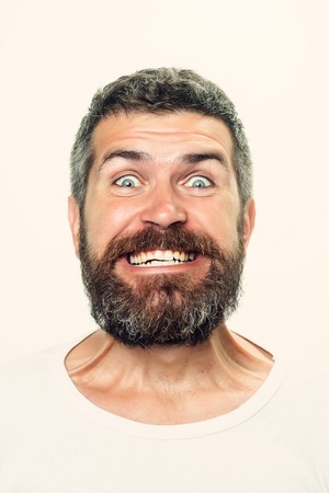 Hipster with happy face. Feeling and emotions. Guy or bearded man isolated on white background. Barber fashion and beauty. Man with long beard and mustache.の写真素材