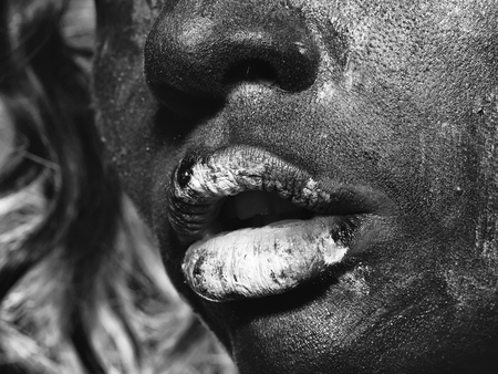 Woman with unusual paint make-up on face and lips closeupの写真素材