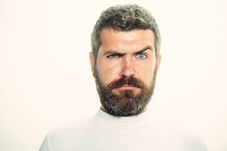 Hipster with serious face. Guy or bearded man isolated on white background. Barber fashion and beauty. Feeling and emotions. Man with long beard and mustache.の写真素材