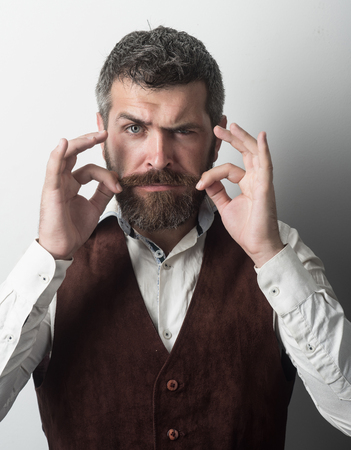 Guy or bearded businessman. Hipster in shirt and waistcoat. Man with long beard and mustache on...