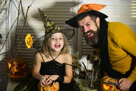 Father and daughter witches with Halloween pumpkin decorの写真素材