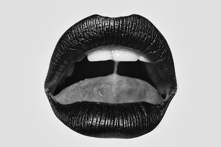 Open female mouth with sexy pink lips tongue and teeth isolated on white background closeupの写真素材