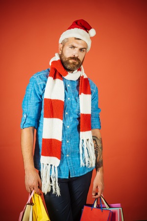 Hipster man hold shopping bags on red background.の写真素材