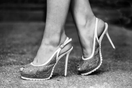 beige shoes female fancy high heel pumps strappy sandals on woman legs beautiful feetの写真素材