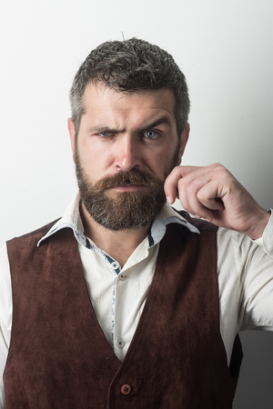Guy or bearded businessman. Man with long beard and mustache on serious face. Fashion model with stylish hair isolated on white. Hipster in shirt and waistcoat. Barber fashion and beauty.の写真素材