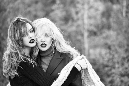 girls with lipstick on lips in scarf outdoor on autumn natural background, copy space, black and whiteの写真素材