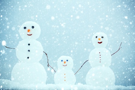 new year christmas snow concept Snowman family in winter outdoor. Christmas or xmas decoration. New year mother, father and child from snow. Happy holiday and celebration. Love and trust.の写真素材