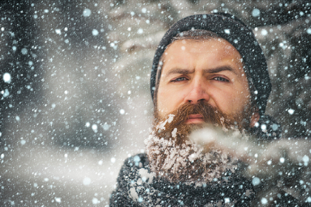 new year christmas snow concept New year man in snowy cold forest. Wanderlust, hiking and travel. Winter holiday and celebration. Man with beard in winter forest with snow. Christmas hipsterの写真素材