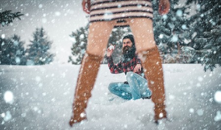 christmas new year snow concept Winter holiday and vacation. New year girl and guy in snowy forest. Christmas couple of happy man and woman. Xmas party celebration. Couple in love with red santa clausの写真素材