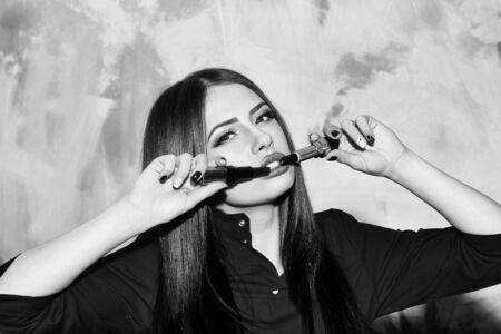 sexy cute woman or pretty girl with brunette long hair and red lipstick on lips in fashionable shirt...