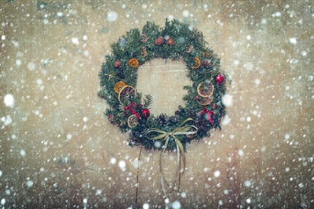 new year christmas snow concept Xmas party celebration. Christmas fir tree wreath. Decoration on beige textured wall background. New year decor. Winter holiday and vacation, copy spaceの写真素材