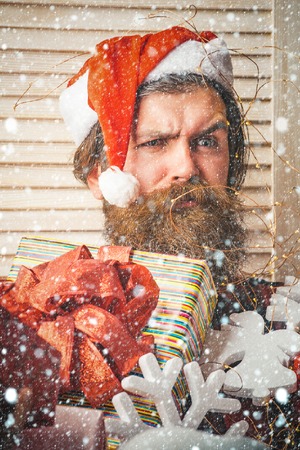 christmas and new year snow concept shopping and party celebration. Winter holiday and xmas. Christmas man with beard on face hold gift. boxing day and cyber Monday, New year. Santa claus manの写真素材