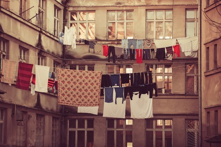 Laundry, garment, linen dry on air outdoor. Clothes hang on clothesline at house backyard. Ecology,...