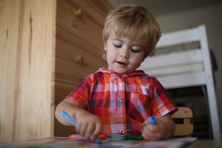 small boy child painter play and draw with marker pen on coloring book, childhood and happiness, education and hobby, art, creativityの写真素材