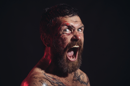 Hipster with beard, mustache shout with horror on black background. Bearded man with tattoo on chest skin. Wizard, sorcerer, warlock. Magic, enchantment, witchcraft. Halloween holidays celebrationの写真素材