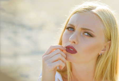 Skincare, skin, make up. Woman with sexy red lips, makeup face. Sensual girl with long blond hair outdoor. Beauty, look concept, copy spaceの写真素材