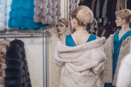 sexy woman in fur coat, shopaholic. woman buy fur coat, shopping, luxury.の写真素材