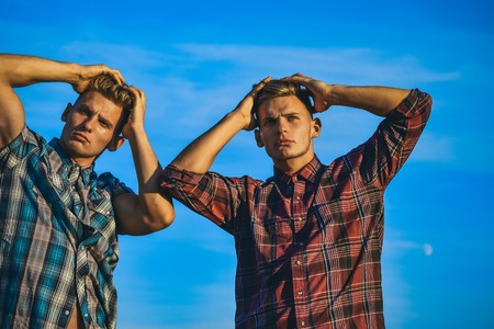 Fashion for men, summer. Man twins with athletic body, family values. Men twins in sunset or sunrise, friendship. Partnership, future, support and trust. Twin brothers man outdoor, relations.の写真素材