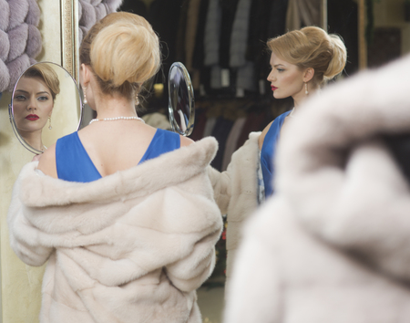 Shopping, seller, fashion model, customer. shopping and winter fashion, woman in fur coatの写真素材