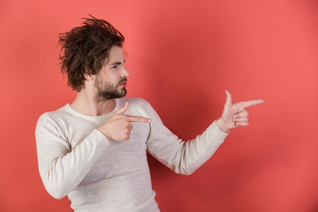 handsome man with uncombed hair presenting product in underwear on red background, morning, single, copy spaceの写真素材