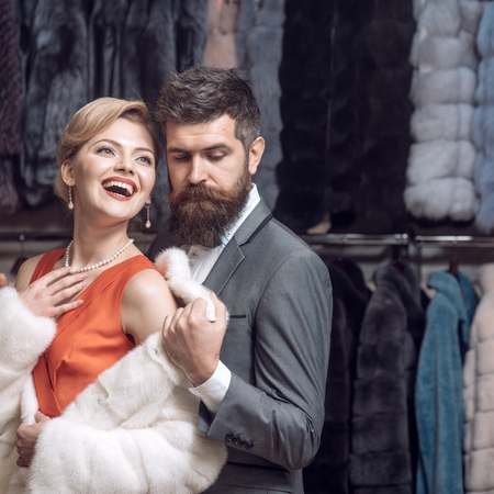Date, couple, love, man and woman. date of couple in love, bearded man embrace sensual woman in fur coat.の写真素材