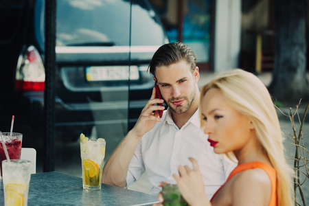 Sexy couple date on summer day. Sensual woman and man in cafe outdoor. Business trip, travel, business concept. Luxury lifestyle, style.の写真素材