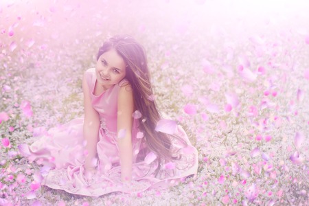 Child in spring flowers. spring flowers background.の写真素材