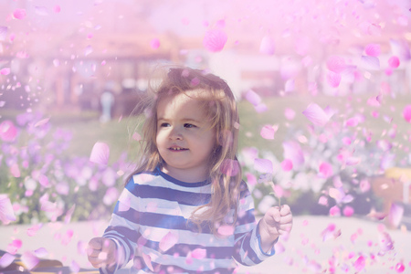 child in blooming flowers. Bloming meadowの写真素材