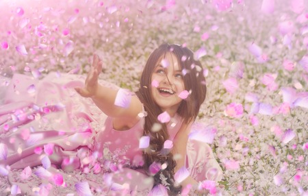 Child in spring flowers. spring flowers background.の写真素材