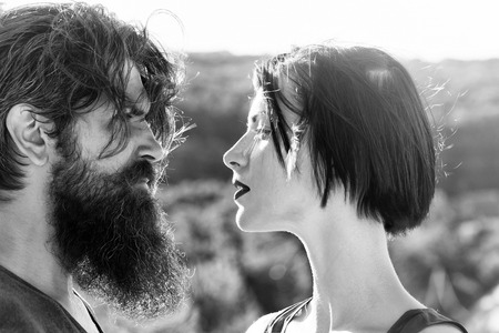 Sensual couple of woman beautiful brunette short hair and man handsome bearded on sunny day on natureの写真素材
