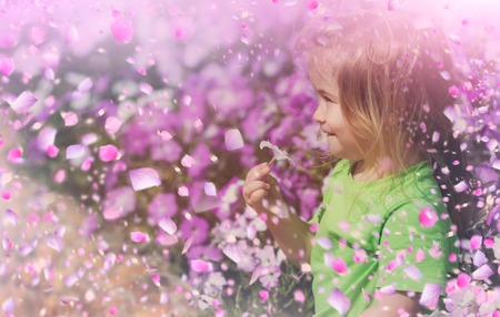 Cute kid plaing in spring meadowの写真素材