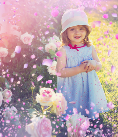 Cute kid plaing in spring meadowの写真素材