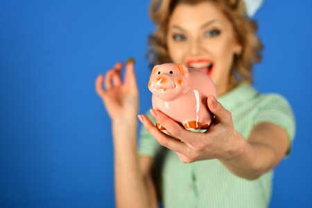 Retro woman hold moneybox, piggy bank for savings. Sensual girl save money for future. Bankruptcy and handout, family budget. Crisis and loan, credit, retro woman. Money, sale, black friday shopping.の写真素材