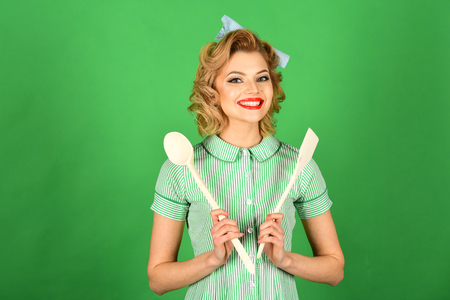 Housekeeper with kitchen utensil, household. Retro woman cooking, gender inequality. Everyday life, housework. Chef cooking, wife. Pinup woman cook hold kitchenware, retro style, maid.の写真素材