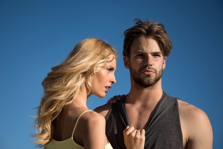family or couple in love of blonde sexy woman and young muscular man on sunny summer blue sky background, love and romance, futureの写真素材