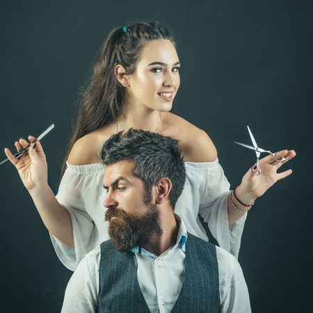 Hairstylist washing client's hair in barber shopの写真素材