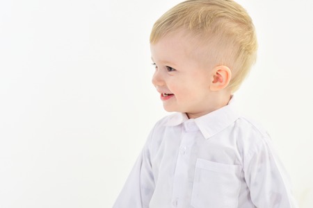Childhood and happiness, little boy. Kid with blonde hair, fashion. Child with happy face isolated on white, white party. Kid fashion, style and look, boss baby. Little boy in white shirt, business.の写真素材
