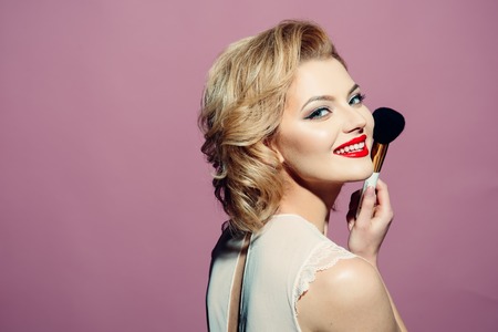 Beautiful young american girl in retro style, pinup. Blond, hairstyle. Retro make-up - red lips, black arrows. copy spaceの写真素材