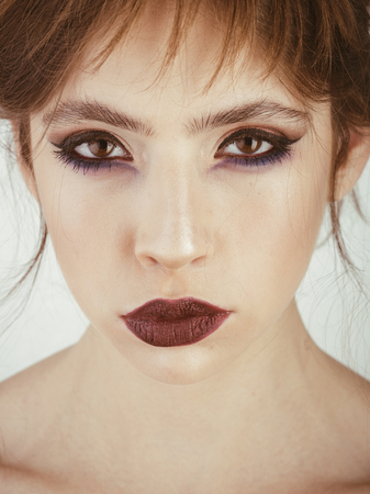 Woman with serious face and elegant make up. Beauty and fashion girl. Fashion look of stylish girl with makeup. Cosmetics for visage and skincare, hairdresser. Woman with makeup isolated on white.の写真素材