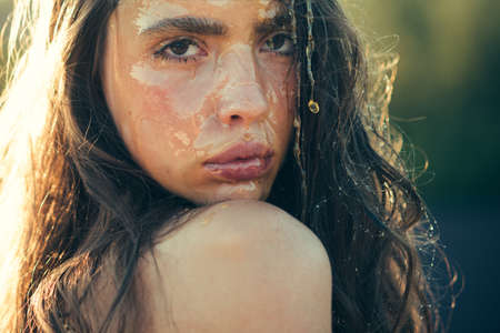 Honey dessert or nectar on woman face. Natural organic facial mask of honey. Beauty and fashion, sugaring. Healthy perfect skin and skincare treatment, diet. Woman with wax mask, cosmetology and spa.の写真素材