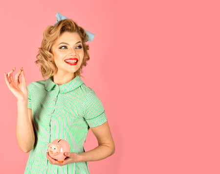 Retro woman hold moneybox, piggy bank for savings. Money, sale, black friday shopping. Bankruptcy and handout, family budget. Crisis and loan, credit, retro woman. Sensual girl save money for future.の写真素材